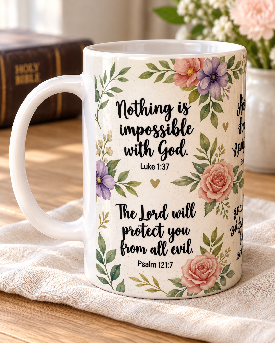White 15 oz Scripture coffee mug with blush and lavender flowers, green foliage, and black Bible verse lettering, styled on ivory linen.