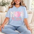 Light blue Made for More Ephesians 2:10 unisex T-shirt with pink gingham, floral lettering, and a printed bow.